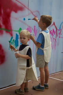 Two Young Boys Painting on Wall
