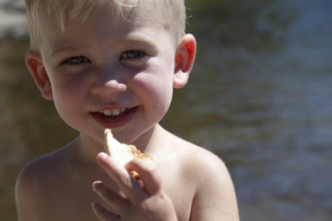 Smiling Boy Eating Bread