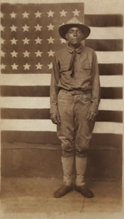 Full-length Portrait of an African American Soldier in Uniform with American Flag in Background, William A. Gladstone Collection of African American Photographs, 1914-18