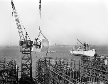 Large Blower being Hoisted into place during Construction of Liberty Ship Frederick Douglass, Bethlehem-Fairfield Shipyards, Baltimore, Maryland, USA, Roger Smith, U.S. Office of War Information, May ...