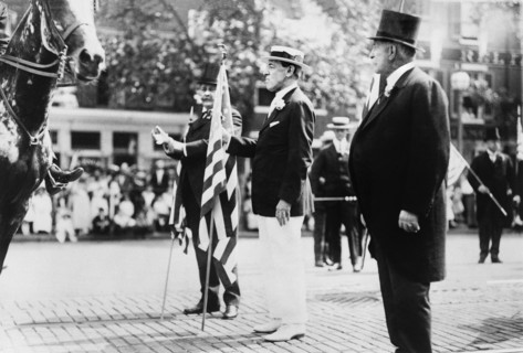 U.S. President Woodrow Wilson, holding U.S. flag, in parade, on Preparedness Day, Washington, D.C., USA, June 14, 1916