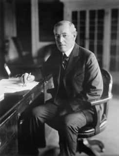 Woodrow Wilson (1856-1924) 28th President of the United States 1913-1921, Three-Quarter Length Portrait seated at desk in White House Oval Office, Washington, D.C., USA, Photograph by  Harris & Ewing,...