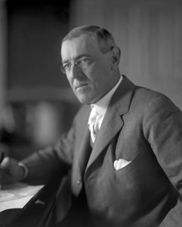 Woodrow Wilson (1856-1924) 28th President of the United States 1913-1921, Half-Length Portrait seated at desk in White House Oval Office, Washington, D.C., USA, Photograph by  Harris & Ewing, 1913-191...