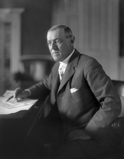 Woodrow Wilson (1856-1924) 28th President of the United States 1913-1921, Three-Quarter Length Portrait seated at desk in White House Oval Office, Washington, D.C., USA, Photograph by  Harris & Ewing,...