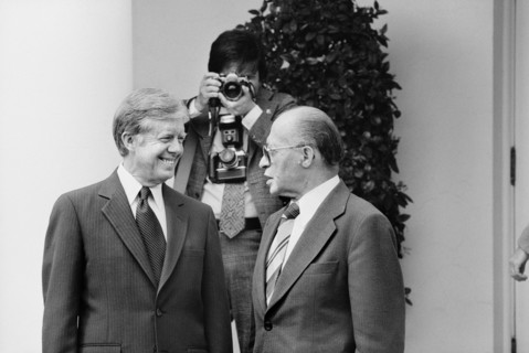 U.S. President Jimmy Carter and Israeli Prime Minister Menachem Begin talk at the White House as photographer adjusts his camera in background, Washington, D.C., USA, photographer Thomas J. O'Halloran...