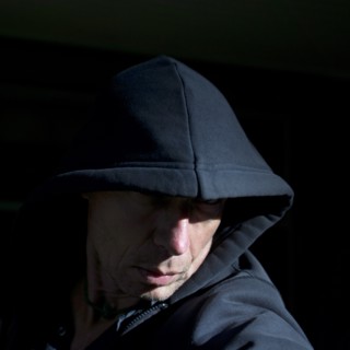 Head and Shoulders Portrait of Man Wearing Hood