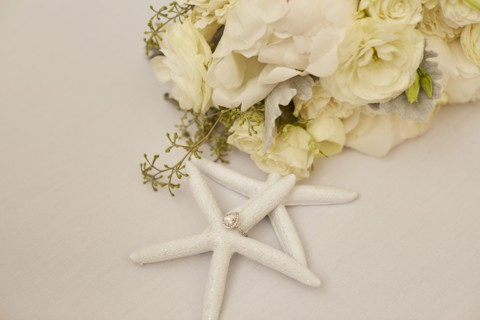 Engagement Ring on Starfish Decoration and Flowers