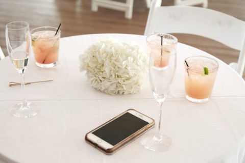 Cocktails and Phone on Wedding Reception Table