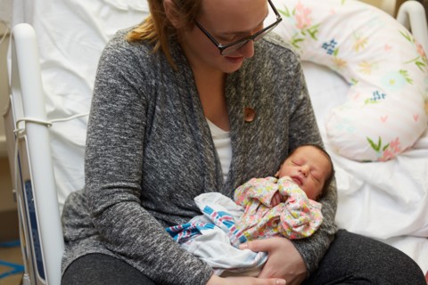 Newborn Baby Girl Being Held by Mother in Hospital