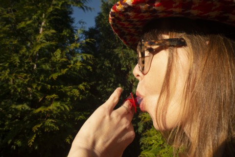 Mid-Adult Woman Sucking on Candy Diamond Ring