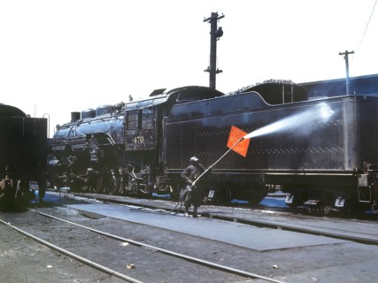 Worker Cleaning an engine near the Roundhouse