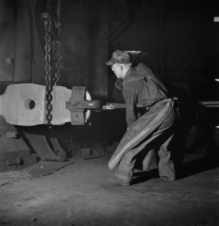 Workman manipulating a Hot Forging which is being hammered under a Steam Hammer at Blacksmith Shop of Atchison