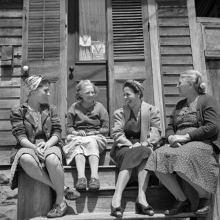 Women talking in Front of Home