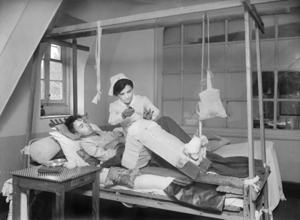 Nurse using Carrel-Dakin Antiseptic Solution on wounded Leg of American Soldier