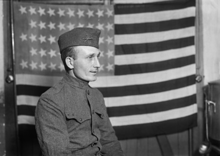 Half-Length Portrait of American Soldier with American Flag in Background