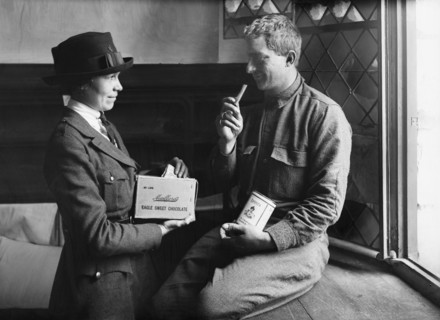 American Soldier receiving Chocolate from Female American Red Cross Worker