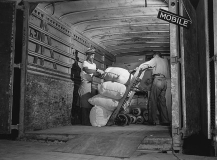 Two Workers loading Truck bound for Mobile