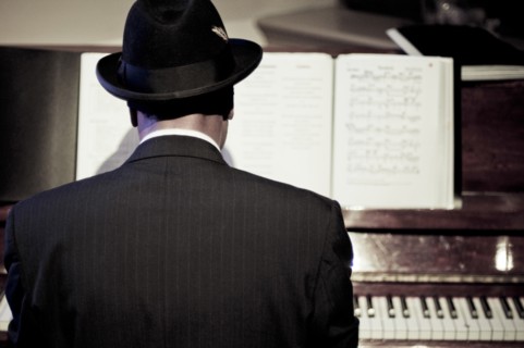 Rear View of Man playing Piano