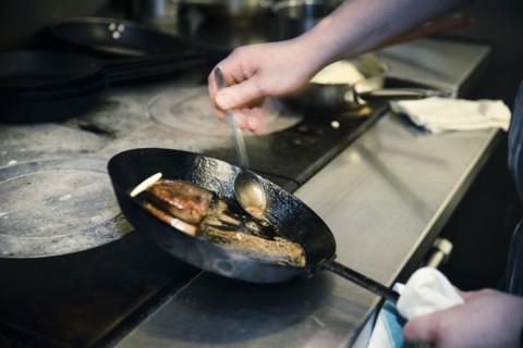 Chef basting Meat in Frying Pan