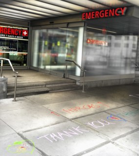 Heroes Thank You Message written on Sidewalk in front of Emergency Entrance to Urgent Care Facility