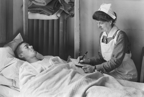 Nurse writing a Letter Home for a wounded American Soldier at the American Military Hospital No. 1