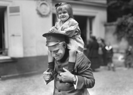 Little Belgian Refugee Girl having on Shoulders of American Red Cross Man at American Hostel for Refugees