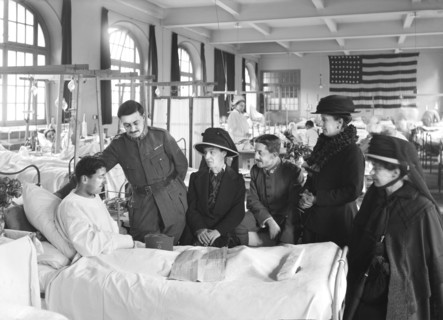 Relatives visiting a wounded French soldier in American Military Hospital No. 1 supported by American Red Cross