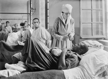 Injured American Soldier receiving Cigarette from American Red Cross Worker at Base Hospital 41