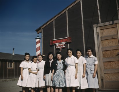 Eight Women standing in front of Camp Barber Shop