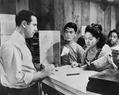 Young woman applies for a money order at Center Post Office from non-Evacuee Official