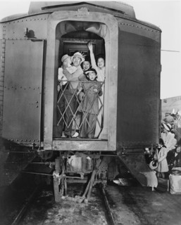 Group of Evacuees of Japanese Ancestry wave good-bye from rear of Train