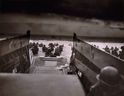 American Soldiers wading from Coast Guard landing barge toward Beach at Normandy