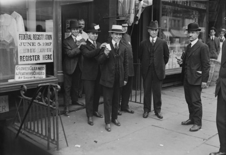 Men holding Draft Cards coming out of Building after registering for the Draft during World War I