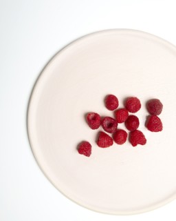 High Angle View of Raspberries on Cropped White Plate