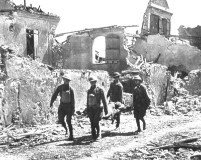 Four Soldiers carrying Wounded Soldier on Stretcher past Bombed-out Building, Vaux, 1918
