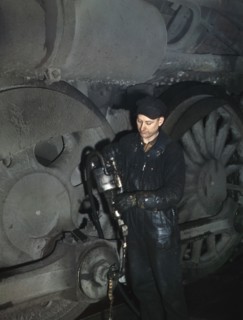 Worker greasing Locomotive in Roundhouse at Proviso Rail Yards, Melrose Park