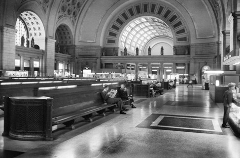 Passengers seated in long benches in the waiting room of Union Station, Washington