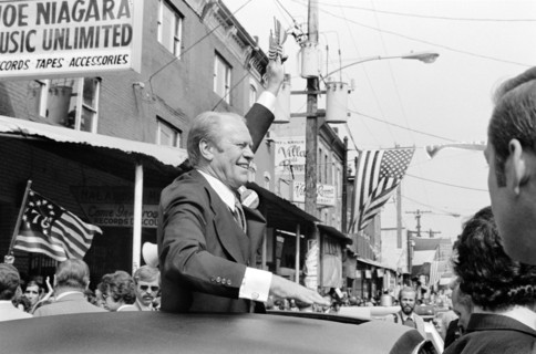 U.S. President Gerald Ford waves to crowd from the sunroof of a car in Philadelphia, Pennsylvania