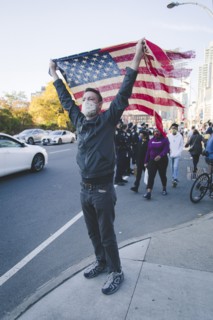 Man holding up American Flag during Celebration of President-Elect Joe Biden, Brooklyn