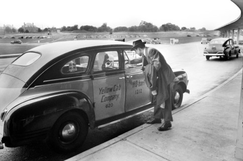 Man paying Taxi Driver upon arrival at Municipal Airport