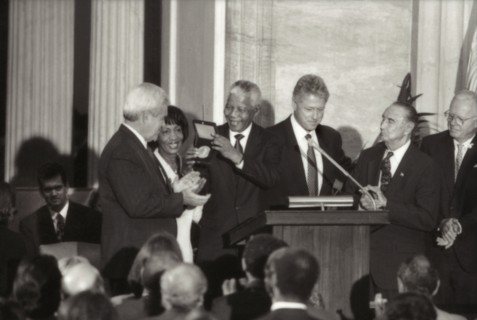 Nelson Mandela receiving Congressional Gold Medal from U.S. President Clinton