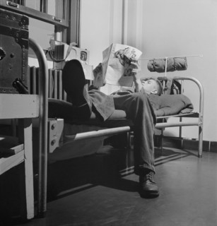 Sergeant George Camblair reading an article in a magazine while relaxing after dinner