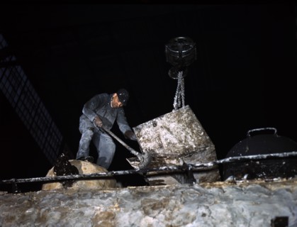 Worker spreading Asbestos Mixture on Boiler of Locomotive at Chicago and North Western Railroad]