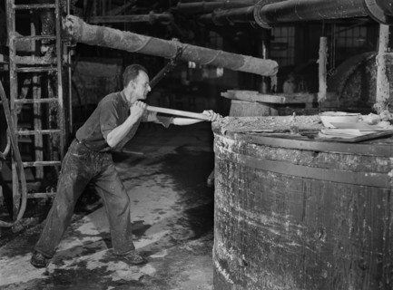 Worker stirring Paper Pulp in Large Vat