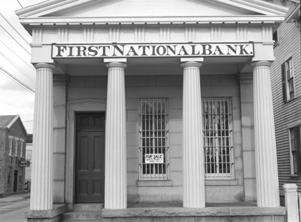 First National Bank with 'For Sale' Sign