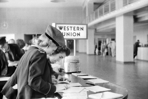 Two Western Union Employees filling out Paperwork