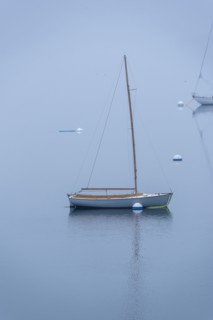 Small Wooden Sailboat moored in Harbor