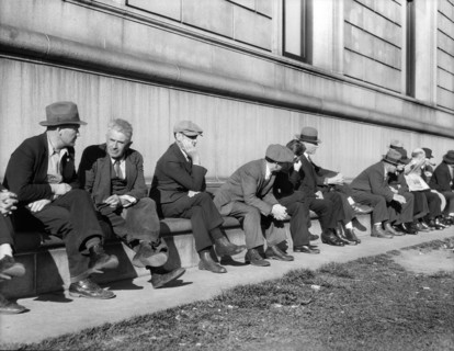 Group of Unemployed Men sitting on side of Public Library