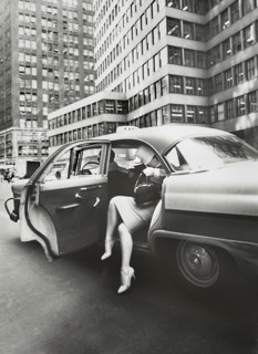 Woman exiting a Taxi