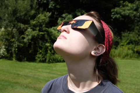 Teenage Girl wearing Eclipse Glasses while viewing Partial Solar Eclipse
